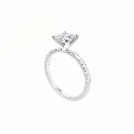 Silver ring with a large diamond and smaller diamonds on the band against a white background