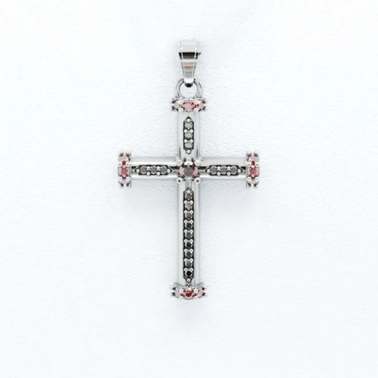 Silver cross pendant with pink gemstones on a white background