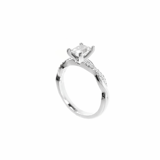 Silver ring with a large diamond and smaller diamonds on the band against a white background