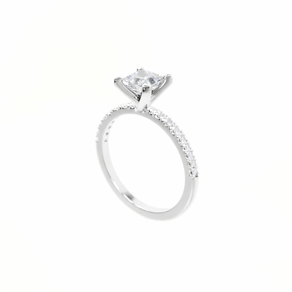 Silver ring with a large diamond and smaller diamonds on the band against a white background