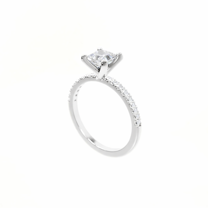 Silver ring with a large diamond and smaller diamonds on the band against a white background