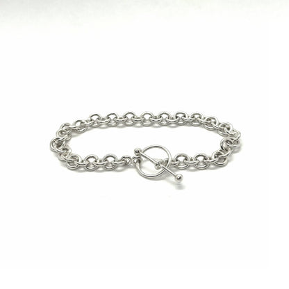 Silver chain bracelet with a toggle clasp on a white background