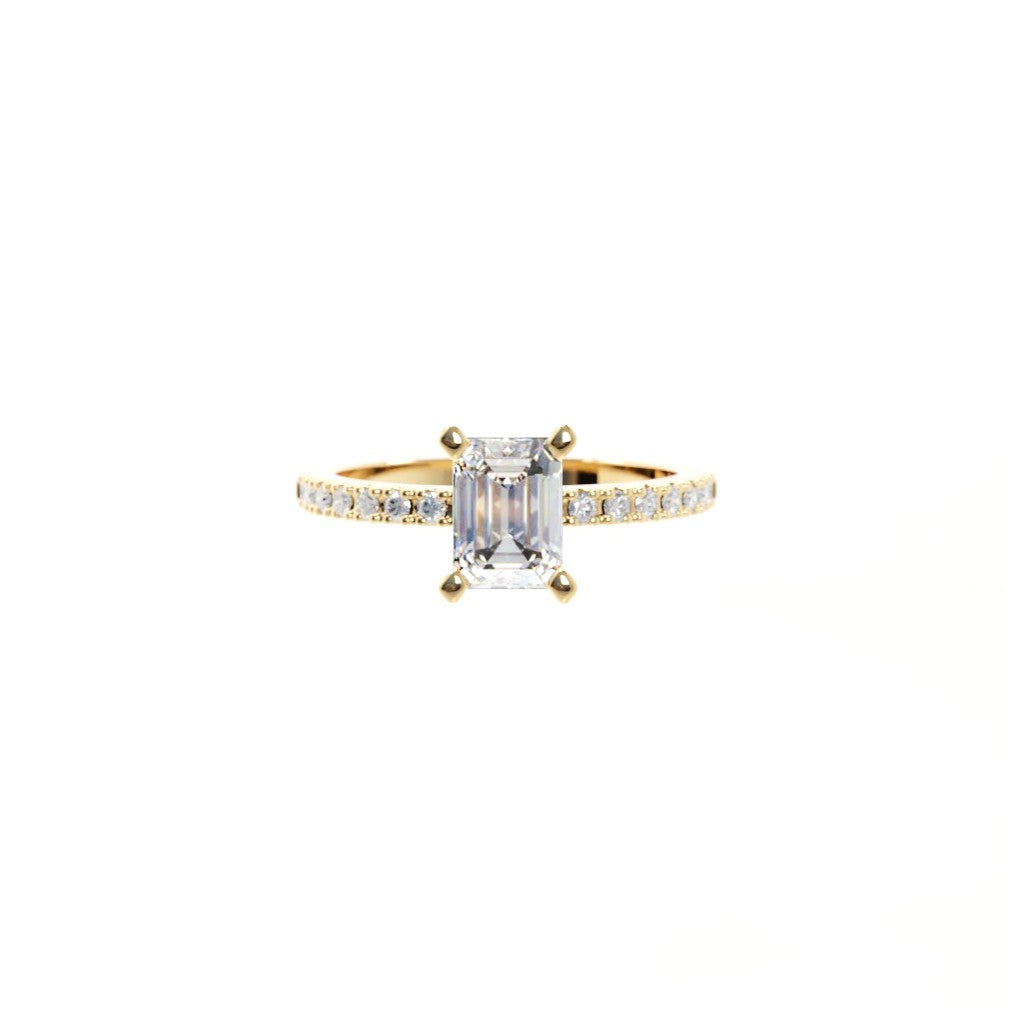Gold ring with a large diamond and smaller diamonds on the band against a white background
