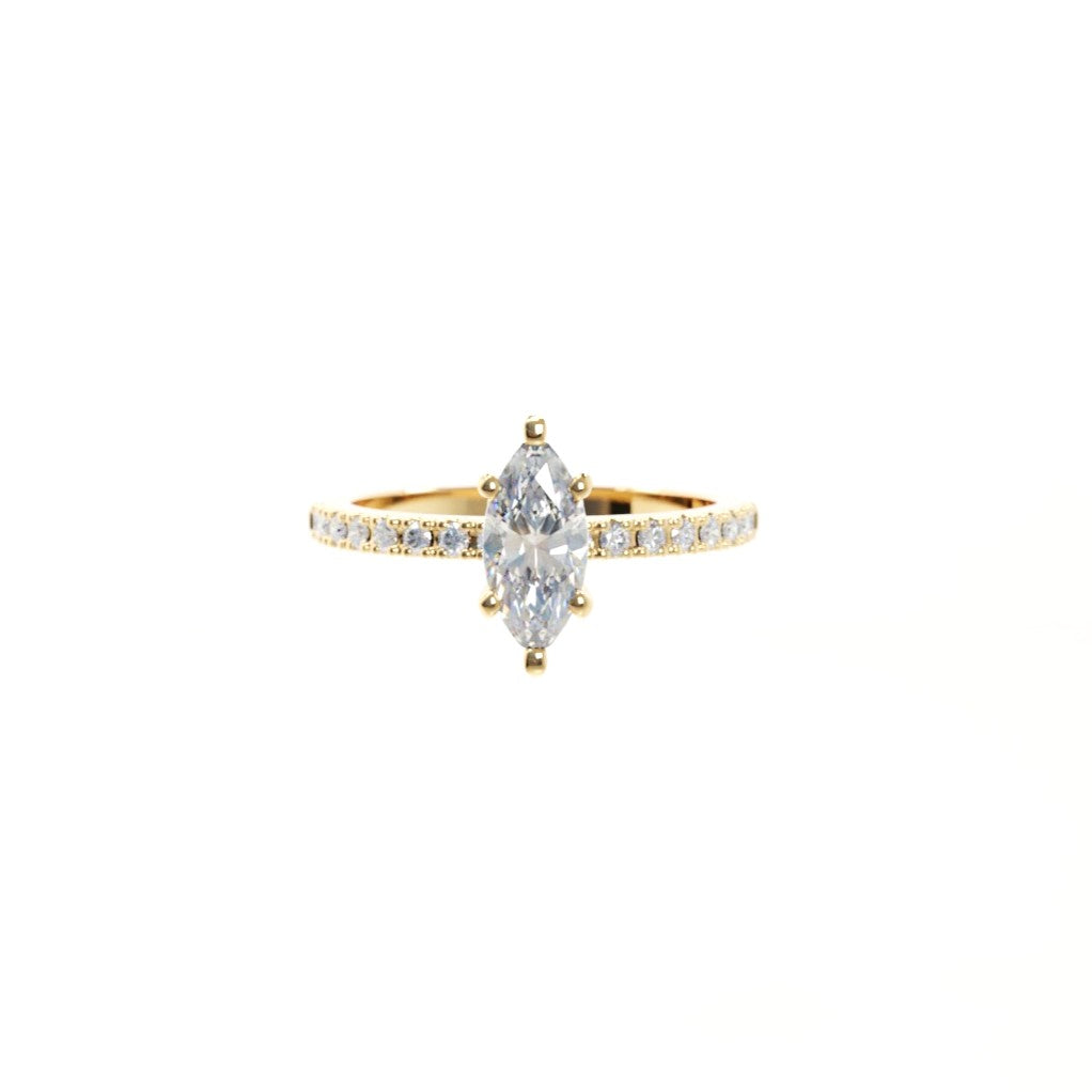 Gold ring with a marquise-shaped diamond on a white background