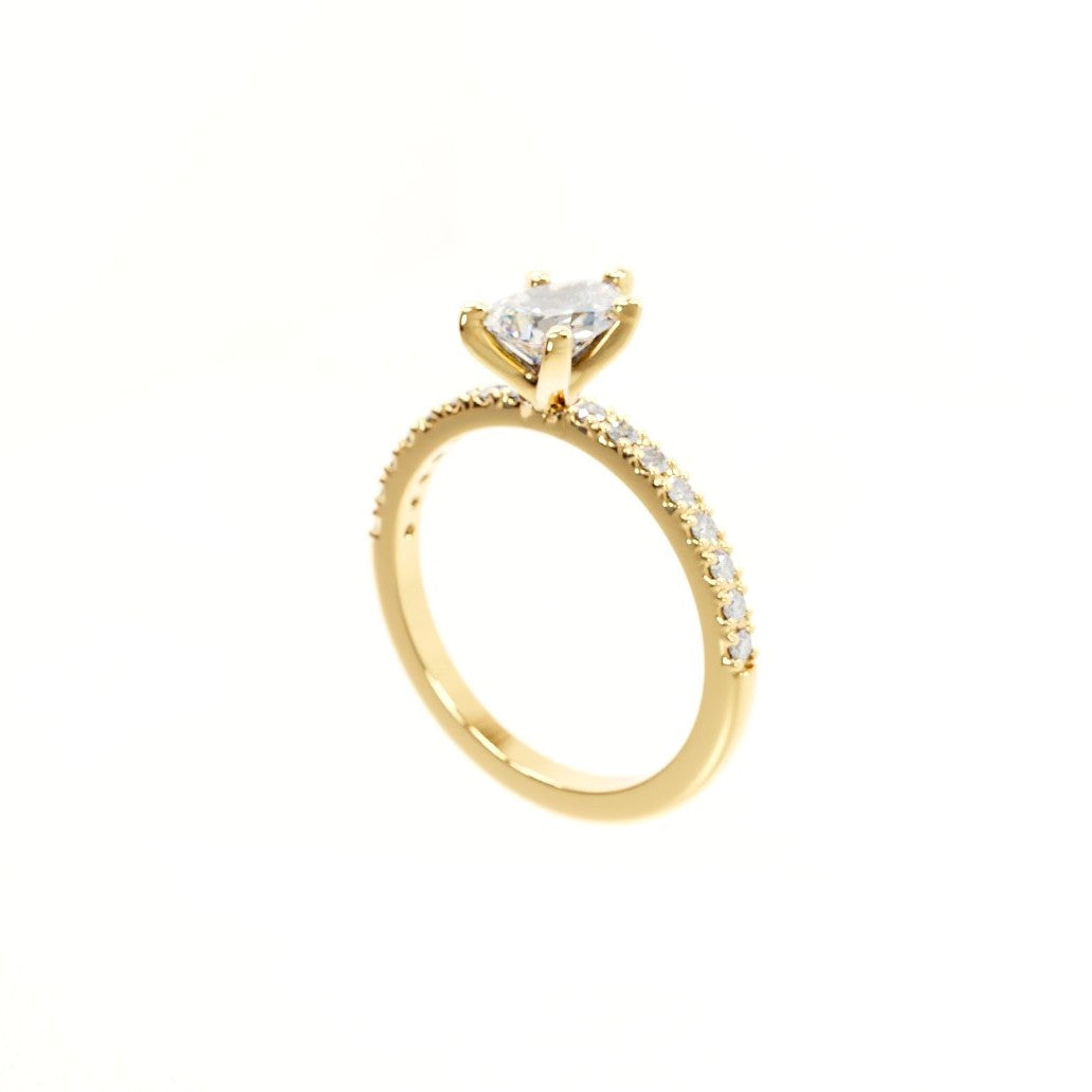 Gold ring with a heart-shaped diamond on a white background