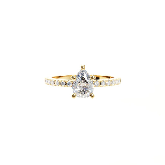 Gold ring with a pear-shaped diamond on a white background