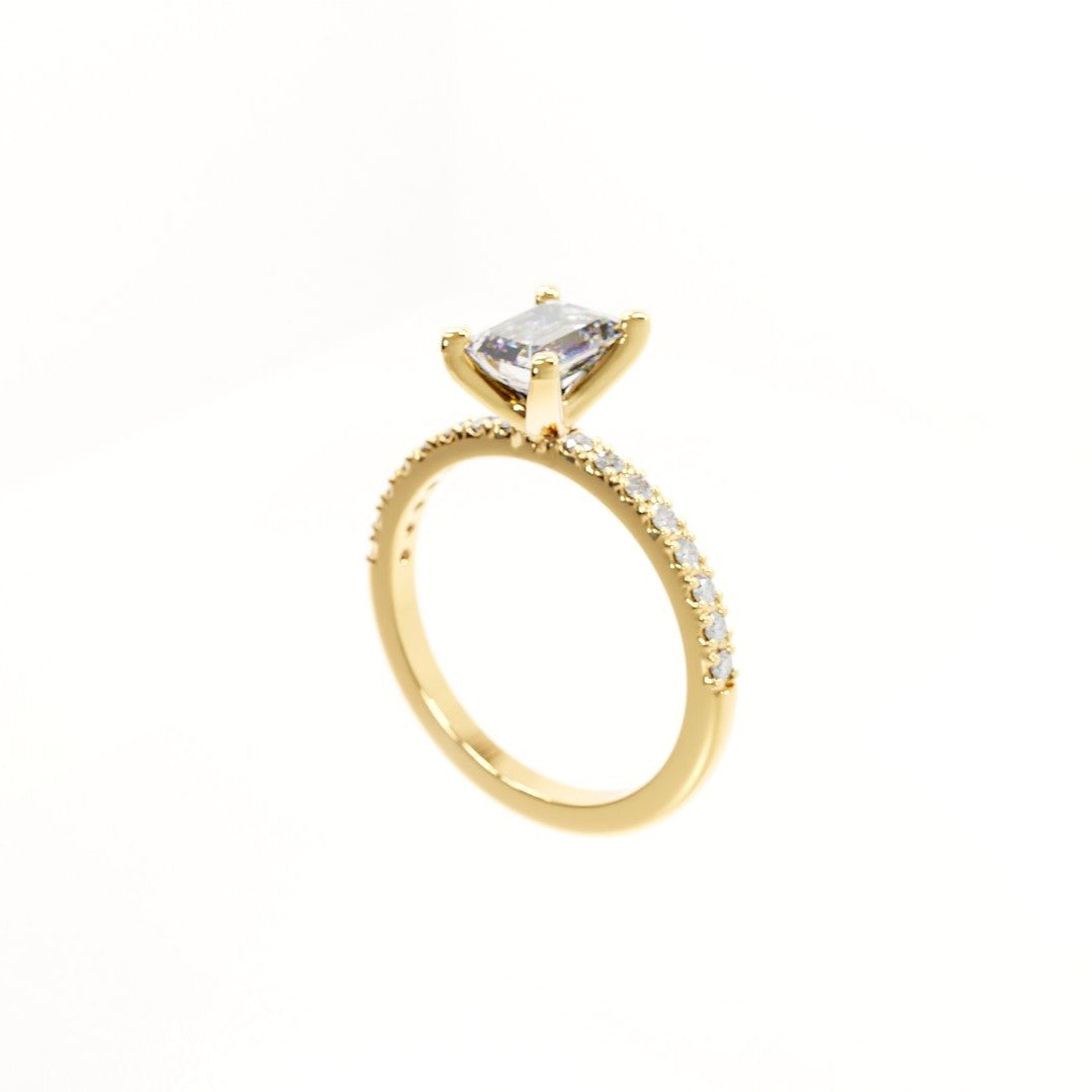 Gold ring with a clear gemstone on a white background