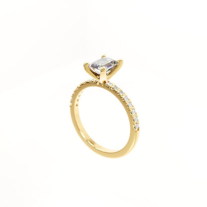 Gold ring with a clear gemstone on a white background