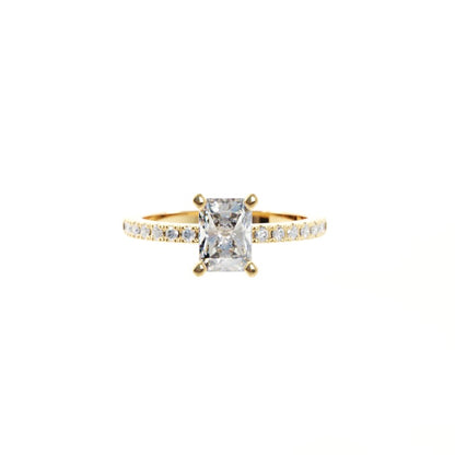 Gold ring with a large diamond and smaller diamonds on the band against a white background