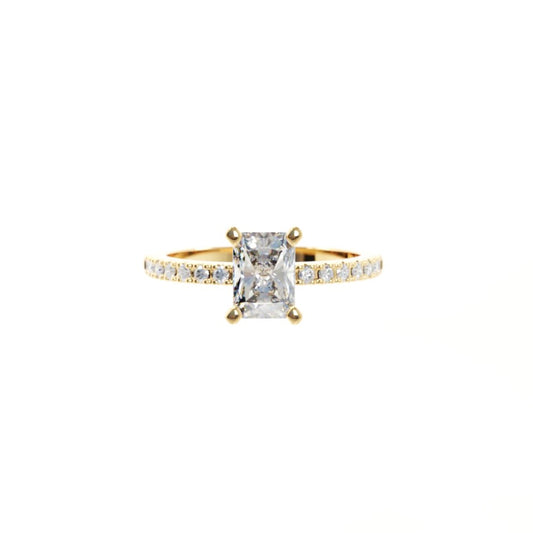 Gold ring with a large diamond and smaller diamonds on the band against a white background