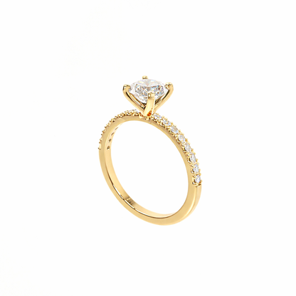 Gold ring with a heart-shaped diamond on a white background