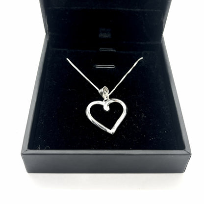 Silver heart-shaped pendant necklace in a black jewelry box