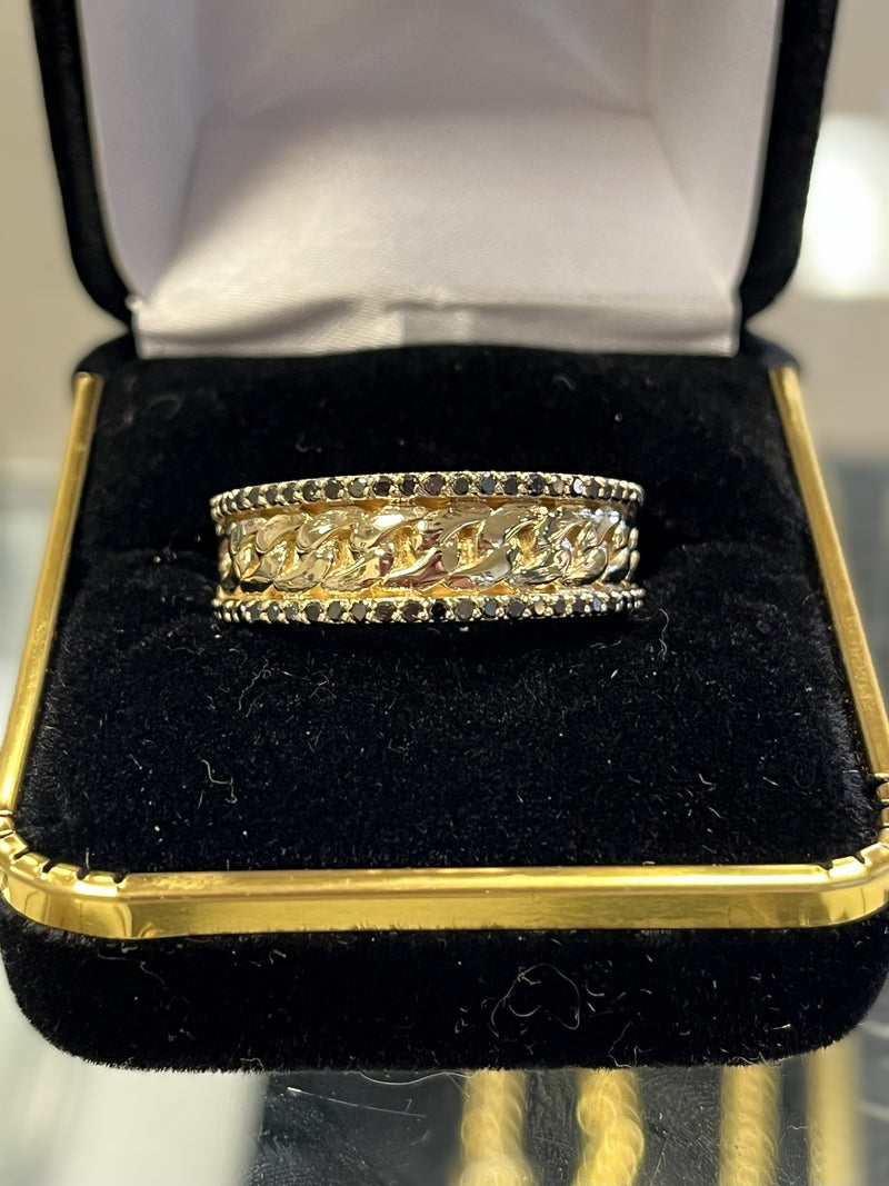 Gold ring with black stones in a gold jewelry box