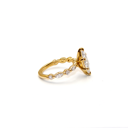Gold ring with diamond accents on a white background