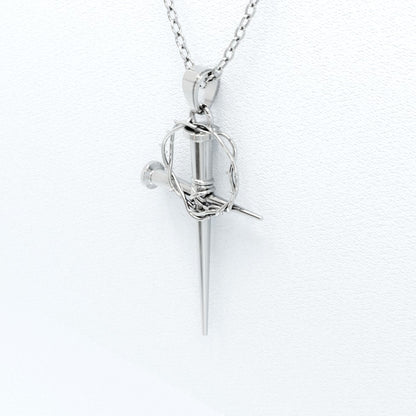 side profile image of silver nail cross pendant with crown of thorns
