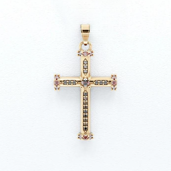 Gold cross pendant with embedded stones on a white background