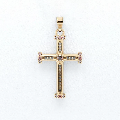 Gold cross pendant with embedded stones on a white background