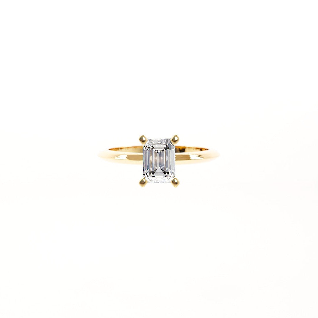 Gold ring with a diamond on a white background