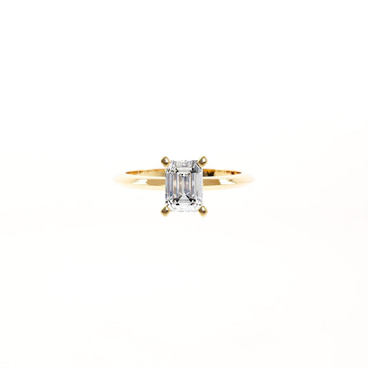 Gold ring with a diamond on a white background