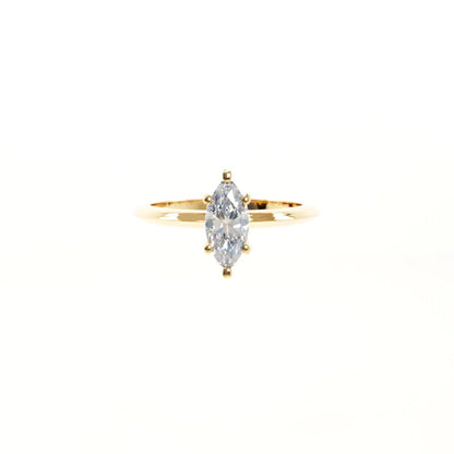 Gold ring with a marquise-shaped diamond on a white background