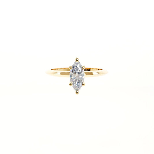 Gold ring with a marquise-shaped diamond on a white background