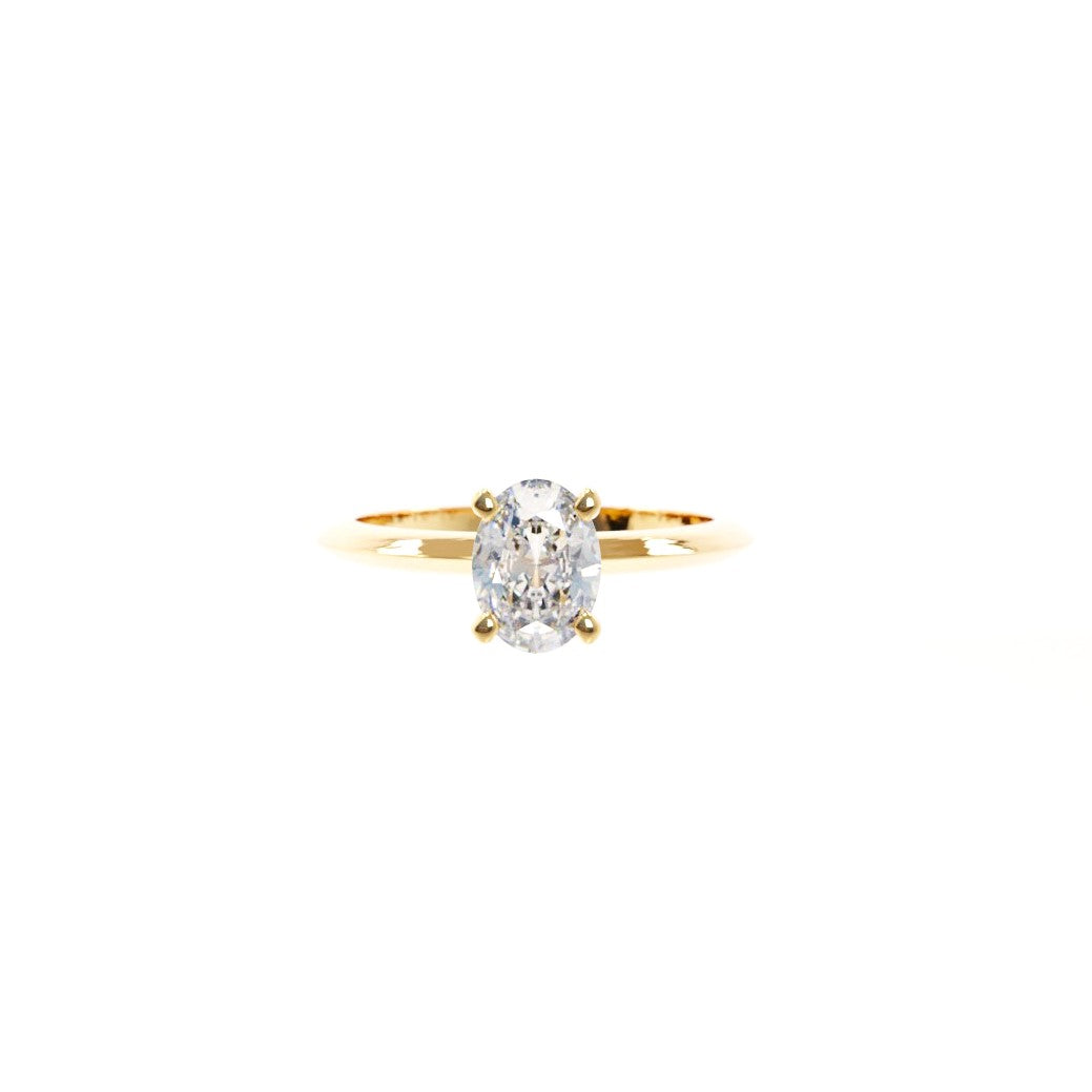 Gold ring with a diamond on a white background