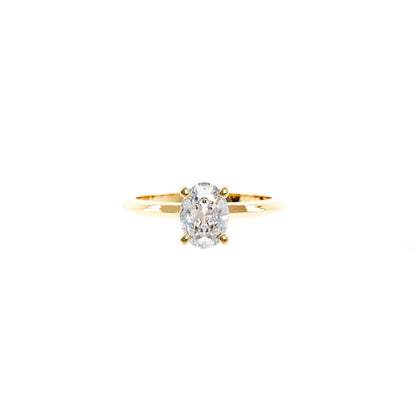 Gold ring with a diamond on a white background