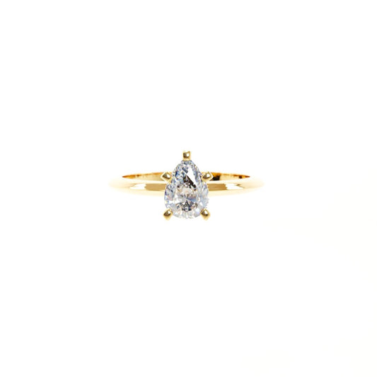 Gold ring with a pear-shaped diamond on a white background