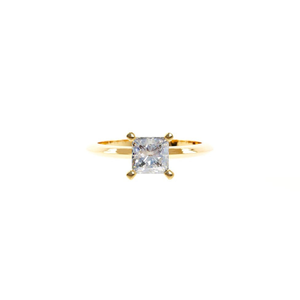 Gold ring with a diamond on a white background