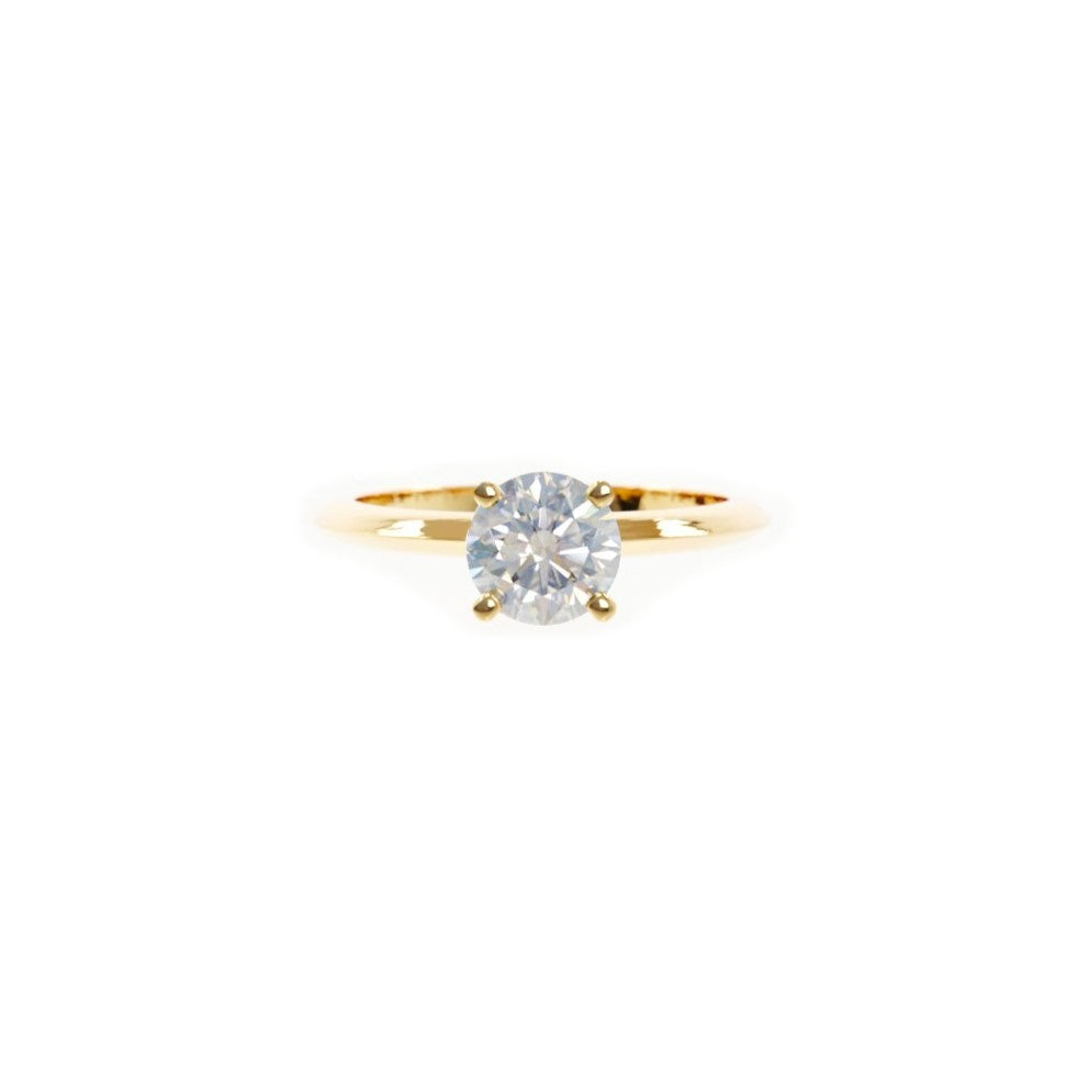 Gold ring with a diamond on a white background