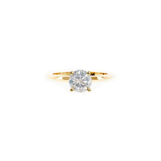 Gold ring with a diamond on a white background