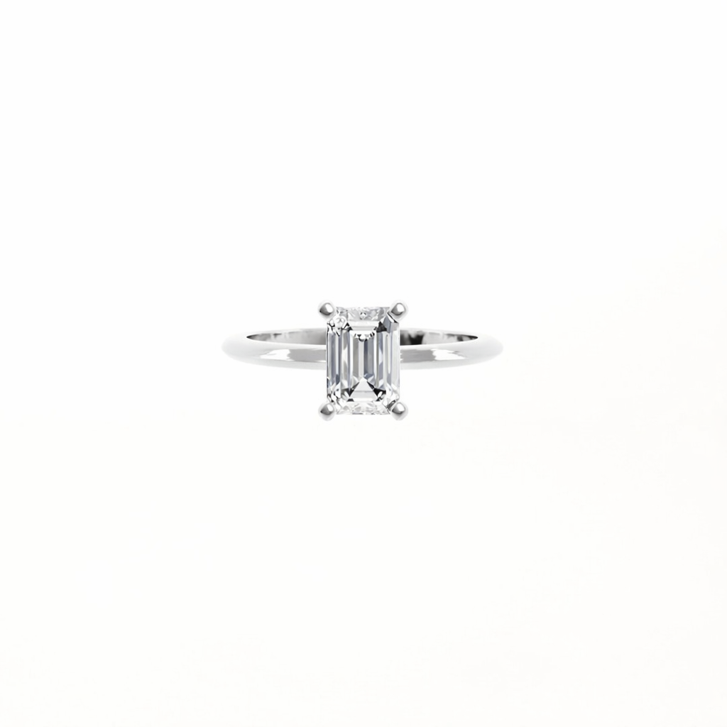 Diamond ring with emerald-cut stone on a white background