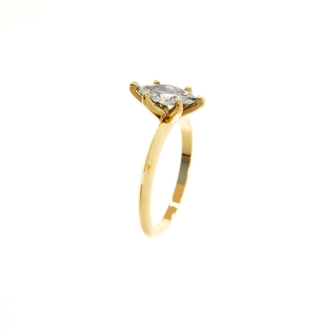 Gold ring with a diamond on a white background