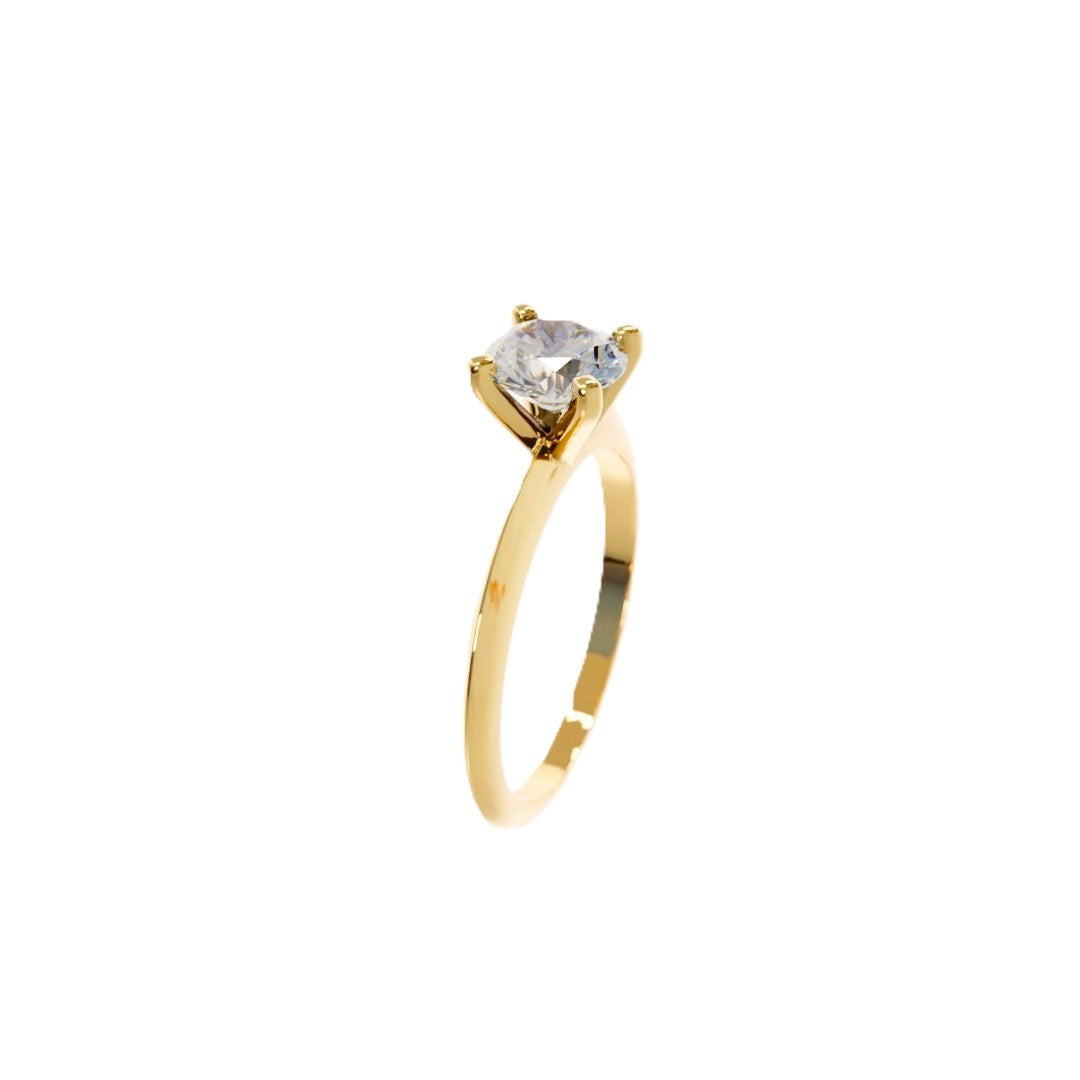 Gold ring with a clear gemstone on a white background