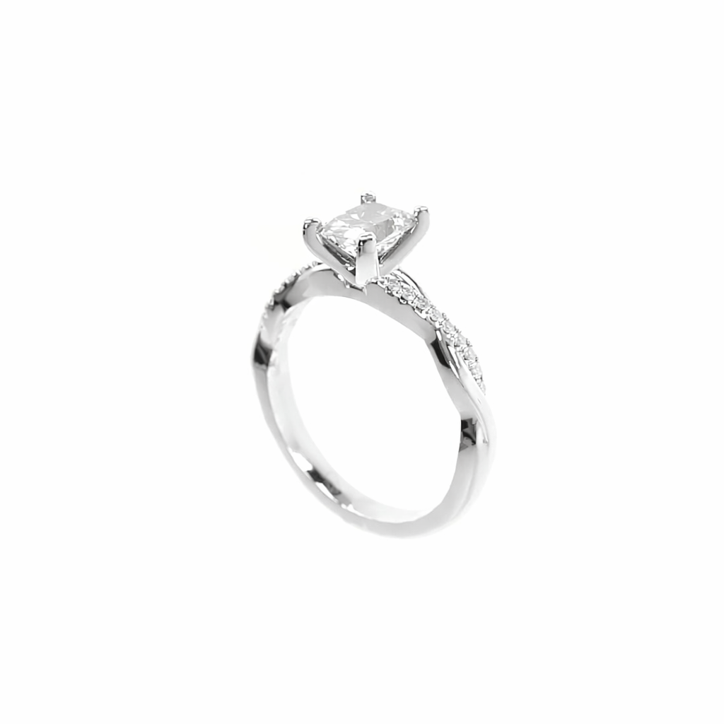 Silver ring with a large diamond and smaller diamonds on the band against a white background