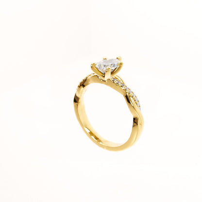Gold ring with a heart-shaped diamond on a white background