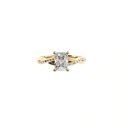 Gold ring with a large diamond and smaller diamonds on the band against a white background